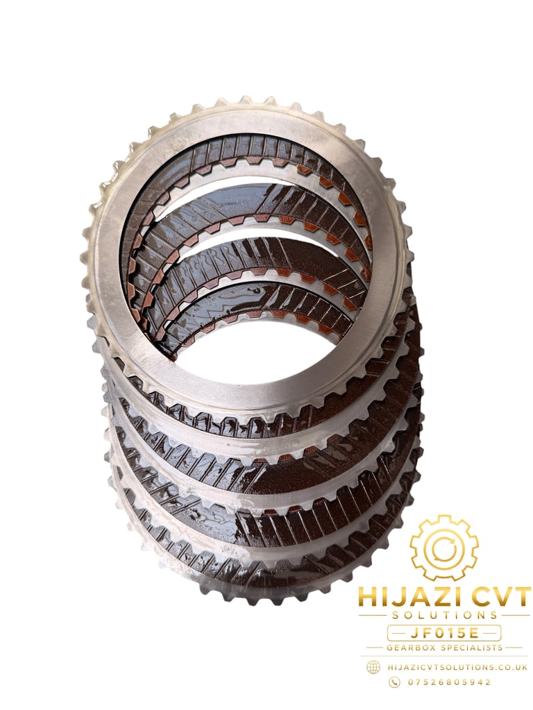 Stack of metallic transmission gears with serrated teeth, marked with Hijazi CVT Solutions logo and contact information