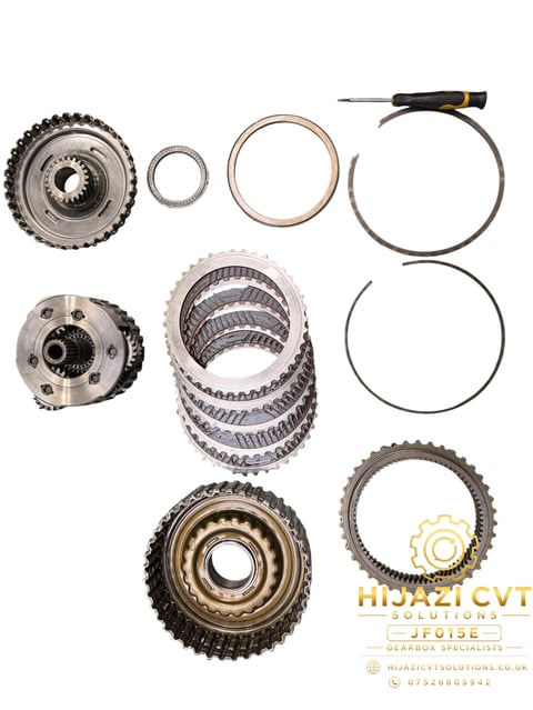 Disassembled CVT transmission clutch components including pulleys, belts, springs, and measuring tool on white background