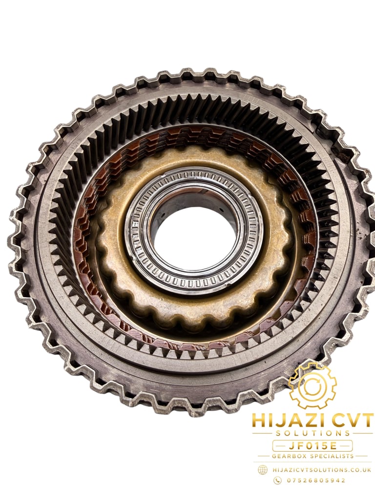 Close-up of a metal transmission gearbox drum assembly with concentric gears and teeth, featuring a central hollow hub and Hijazi CVT Solutions branding