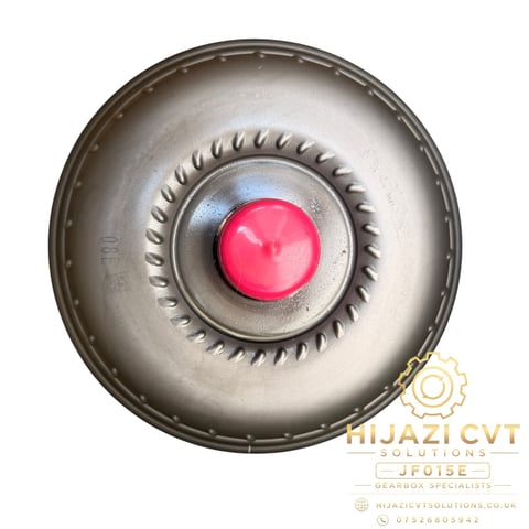 Top view of a torque converter with red dome center, serrated clutch ring, and gray metal housing