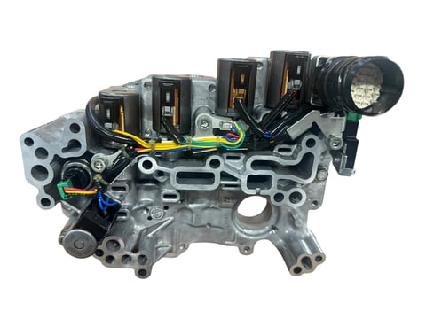 Engine control module with black relay components and wiring harness on metal housing
